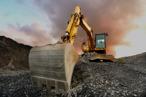 Image of a wheeled excavator on a quarry tip Image of a wheeled excavator on a quarry tip