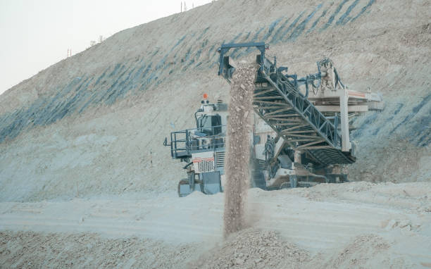 Quarry harvester unit with heavy equipment. Construction industry. building a road and hotel on the Dead Sea, Israel. horizontal blue sky and white clouds background