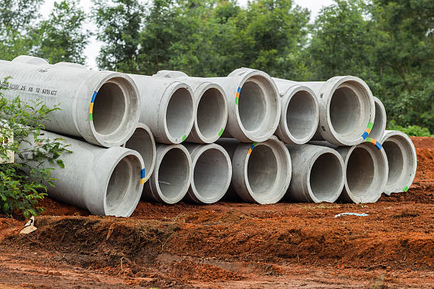 Concrete water pipes stacked ready for installation on civil engineering construction project site